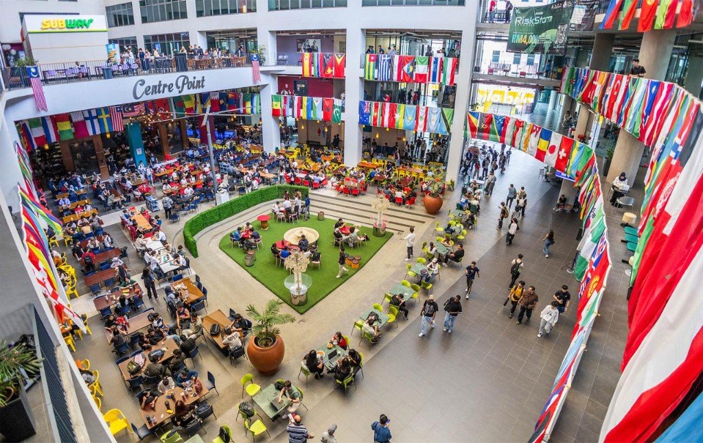 Campus atrium with students and international flags